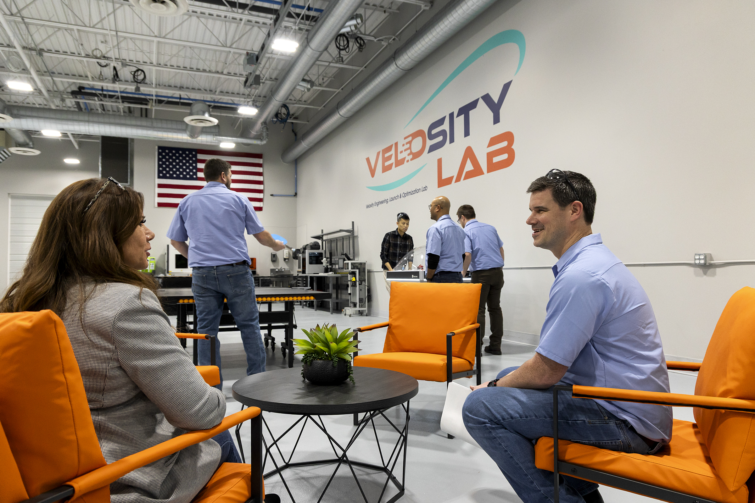 Two people talk in the Velosity Lab