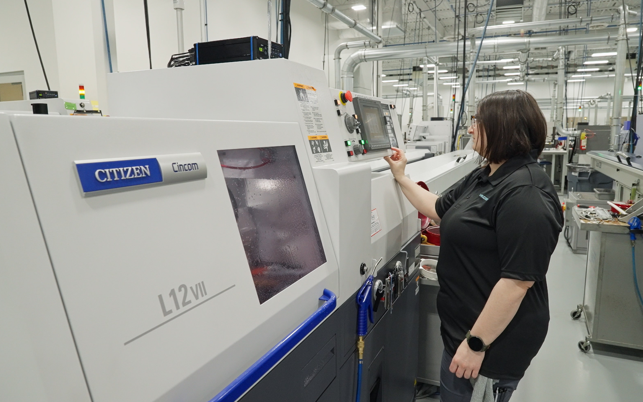 A Velosity employee works on a Swiss Machine.