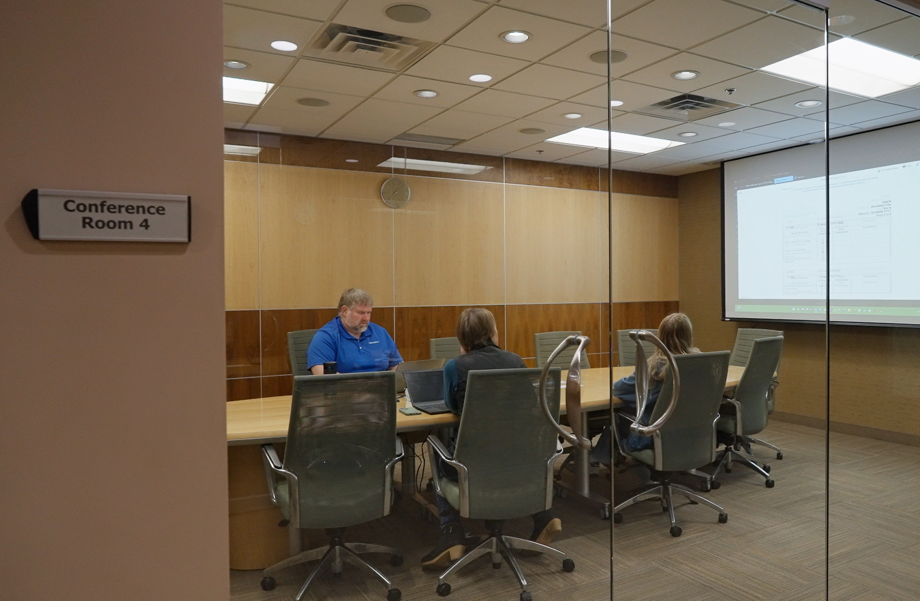 A group of Velosity employees in a meeting in a conference room.
