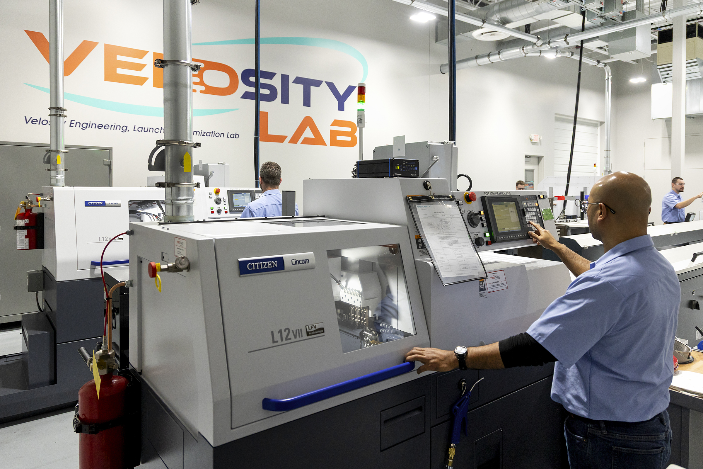 A technician operating a Citizen CNC lathe machine at the Velosity Engineering, Launch and Optimization Lab in Brooklyn Park.