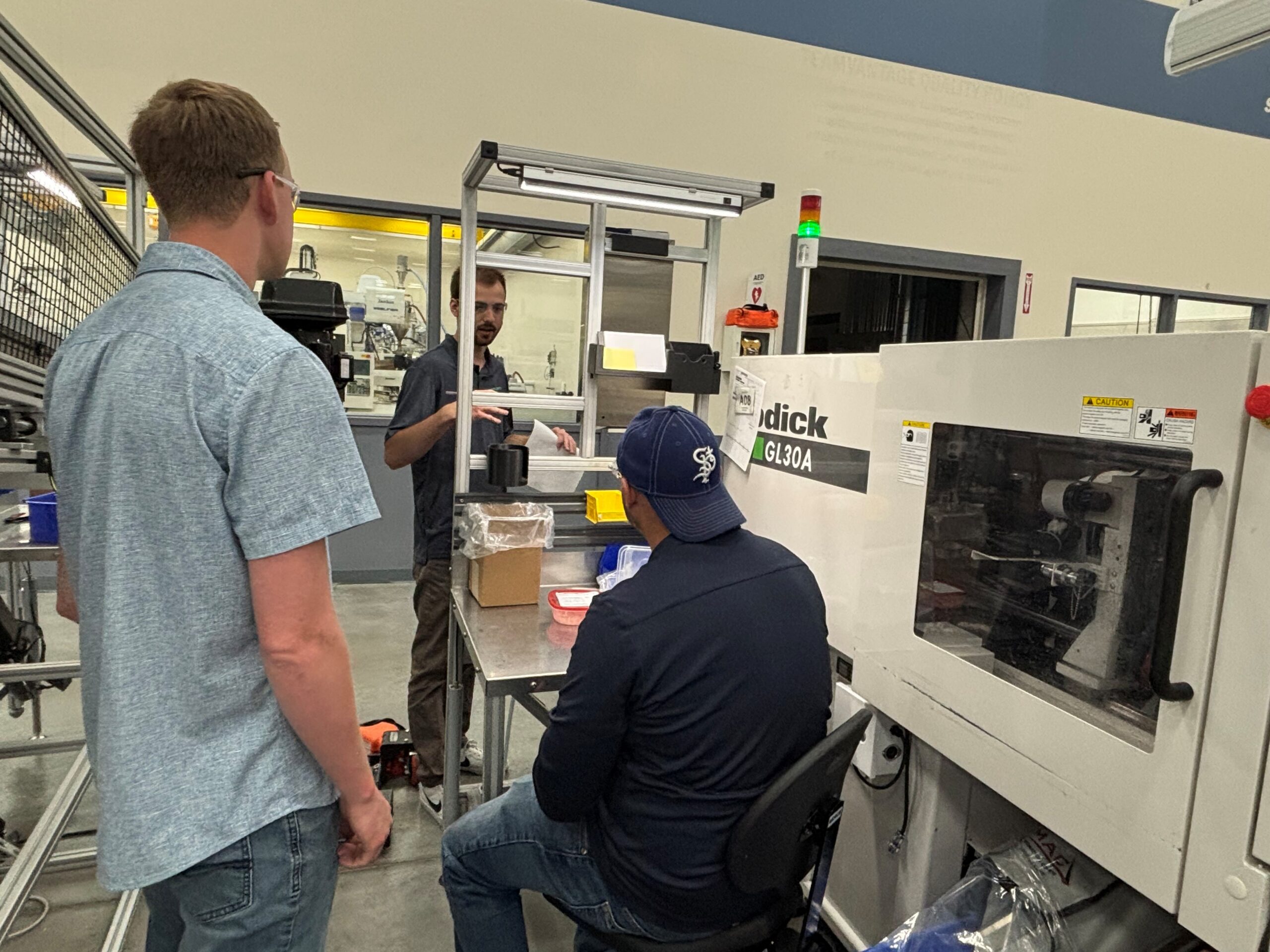 Velosity employees stand around machinery