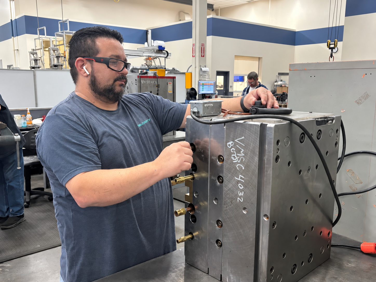 Embedded Engineering Manufacturing Readiness no Logo (1) Velosity employees gather to look at plans