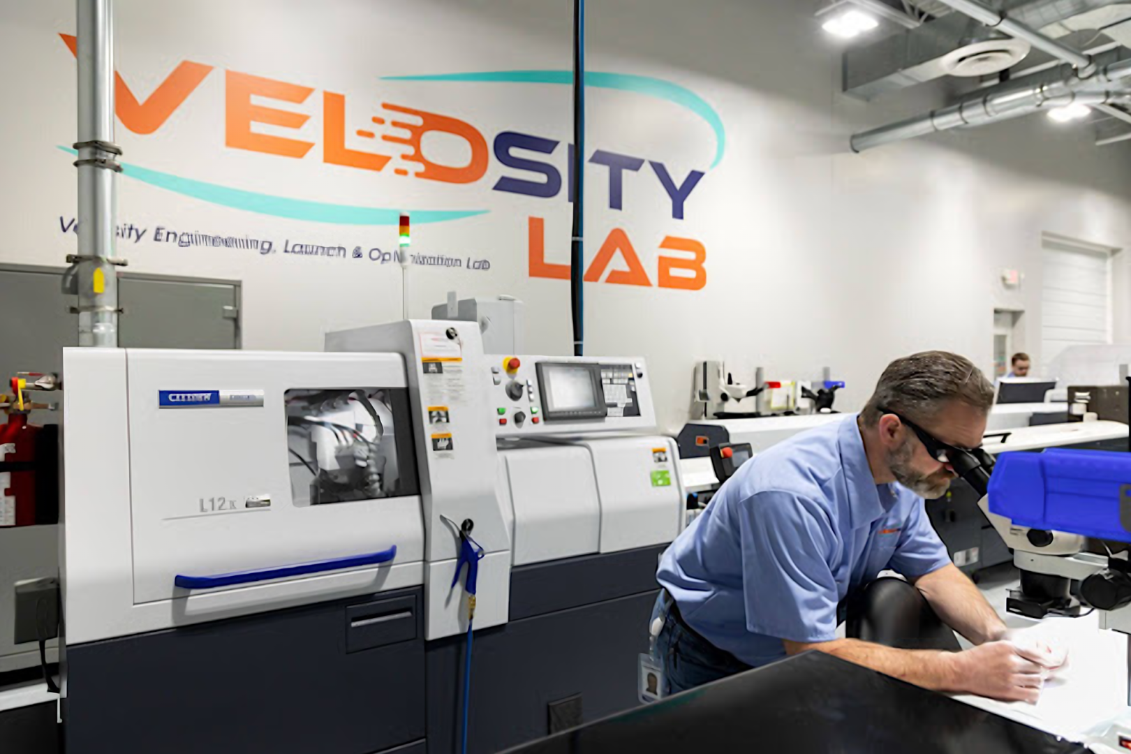 velosity-lab-machining-1620x1080 Velosity employees gather to look at plans
