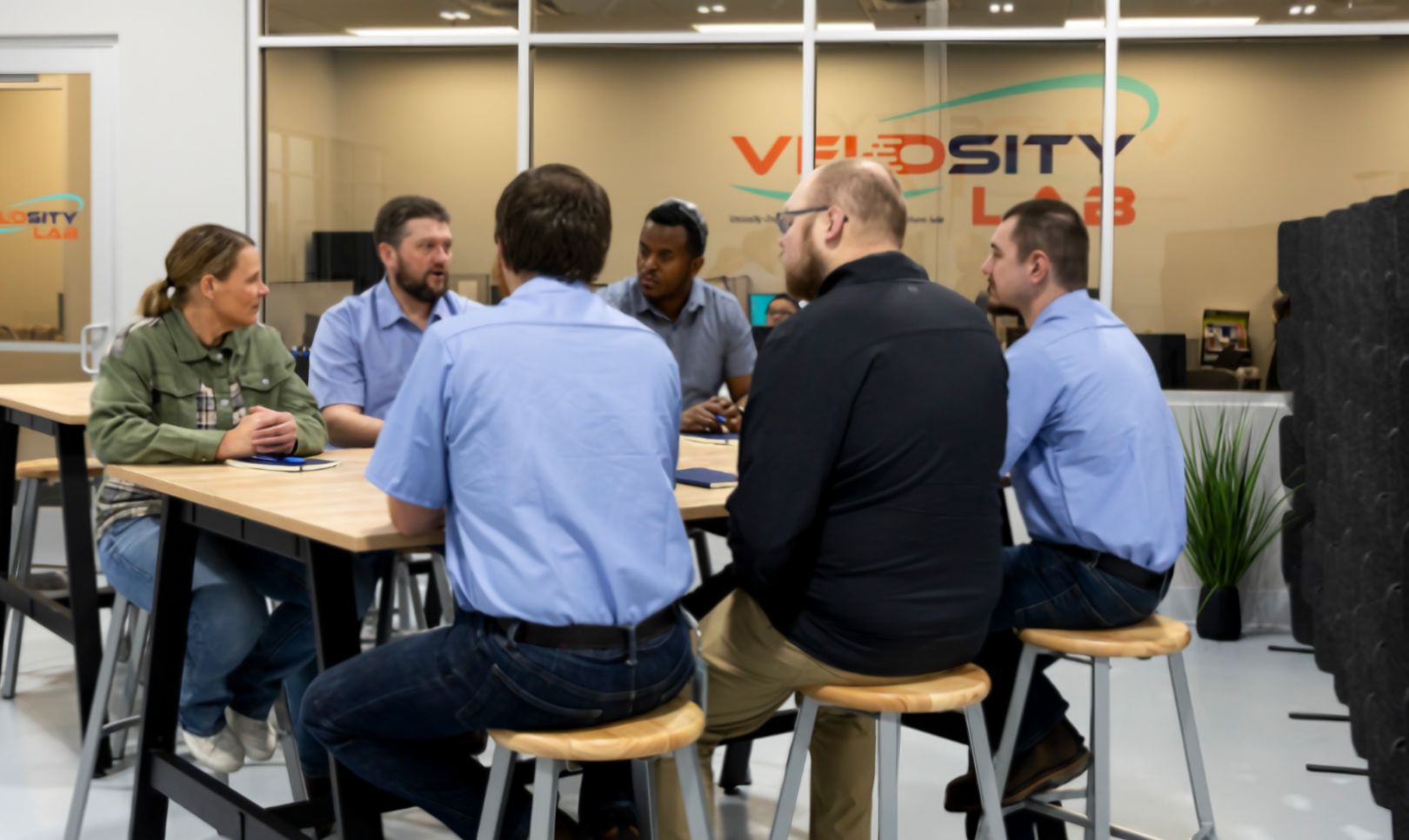 velosity-lab-team-meeting-1620x966 A group of Velosity employees in a meeting in a conference room.
